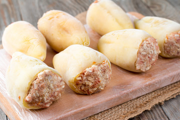Frozen stuffed peppers on a cutting board. Frozen food