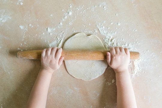 Children's hands rolled dough