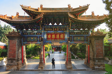 Huge oriental stone gate leading to Chinese Buddhist temple