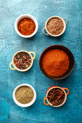 Obraz na płótnie Canvas Spices and condiments in small bowls