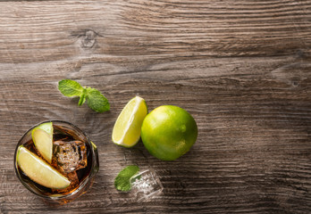 Top view of Cuba libre cocktail on wooden table