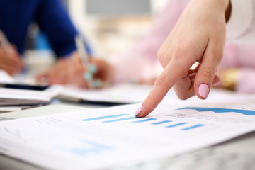 Fototapeta premium Female arm point pinger in financial graph