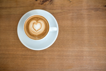 Coffee cappuccino on a wooden table in a café with space to write