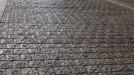 Surface of cobblestone road.