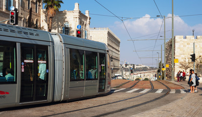 Obraz premium Modern tram goes along the street of Jerusalem.