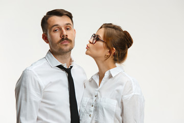 The business man and woman communicating on a gray background