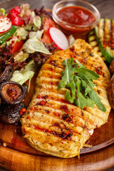 food concept - Chicken steak with a light salad, zucchini and mushrooms grill