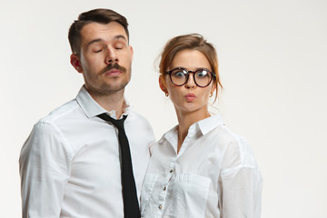 The business man and woman communicating on a gray background