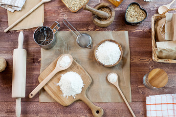 wheat and flour on rustic wooden table, top view
