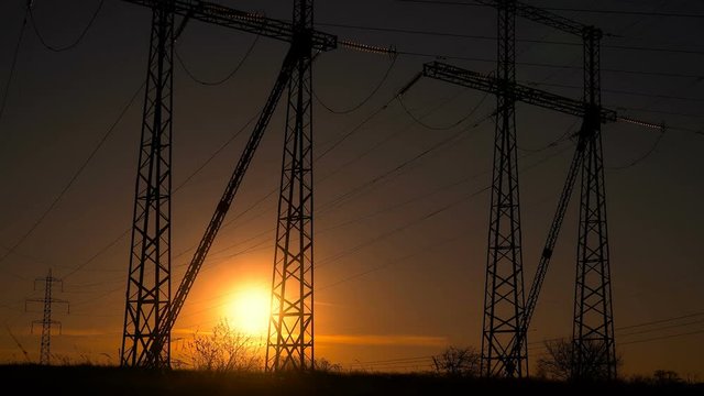 High-voltage power lines at sunrise. Fuel and power generation Timelapse.