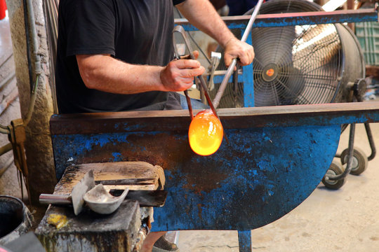 Artisan manufactures glass. Glassworks process.