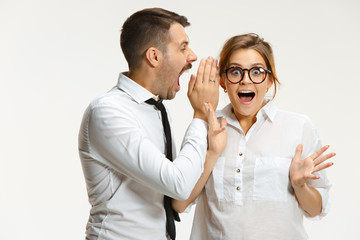 The business man and woman communicating on a gray background