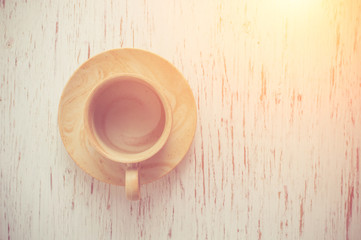 Coffee cup on rustic wood background.