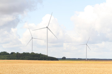 Countryside photo of windturbines working in action.