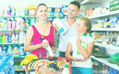 Smiling people showing household goods purchase