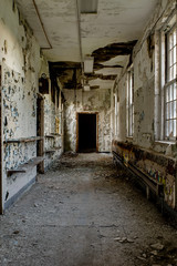 Fototapeta na wymiar Crumbling Hallway with Windows - Abandoned Hospital