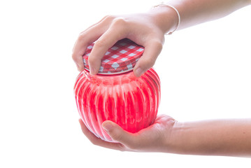 Close up of hands opening a jar.