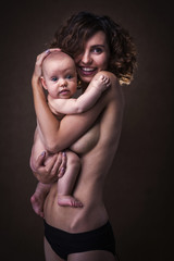 Naklejka premium Young mother holding a baby in her arms
