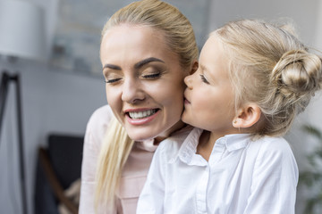 child kissing mother