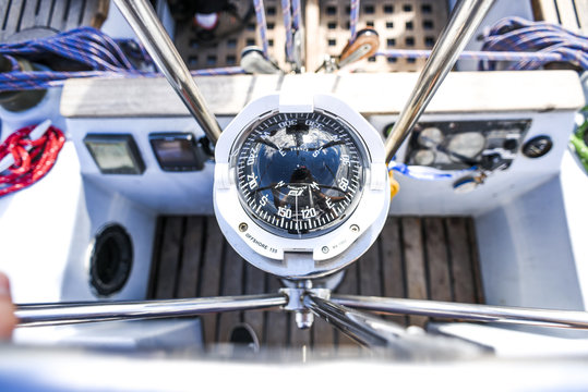 A compass, a view from above the steering wheel on a yacht.
