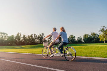 senior couple riding bicycle