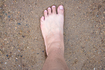 Barefoot walking on the sand In time to relax