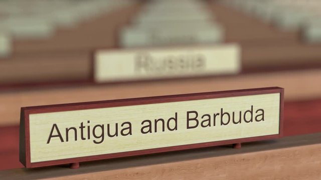 Antigua and Barbuda name sign among different countries plaques at international organization. 3D rendering