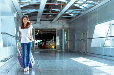 Young girl asian traveler walking with carrying hold suitcase luggage and passenger for tour travel...