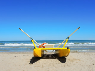 Yellow rescue boat on Italian beach. Adriatic sea. Emilia Romagna. Italy