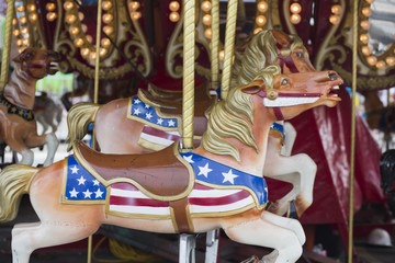 Fototapeta na wymiar Horses on Merry Go Round in midway at the Indiana State Fair