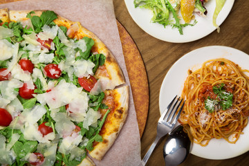 Italian Pizza, salad and Spaghetti on wooden table - 168066633