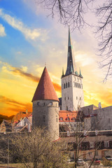 Beautiful view of the tower Oleviste Churchand the Fortress wall in Tallinn, Estonia, on a sunny day