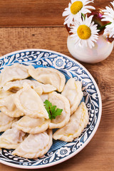 Varenyky, vareniki, pierogi, pyrohy or dumplings, filled with meat (and onion or mushrooms), can be served with sour cream