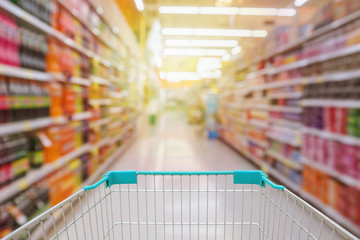 Shopping cart view with Supermarket aisle blurred background