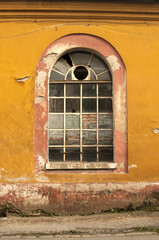 Fototapeta na wymiar Old vintage weathered crumbling grunge glass window of abandoned industrial building