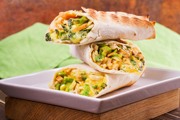 Wraps with chicken, avocado, cilantro and cheese. Chicken burrito