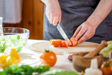 Obraz na płótnie Canvas Chef cutting fresh and delicious vegetables for salad