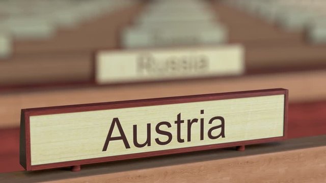 Austria name sign among different countries plaques at international organization. 3D rendering