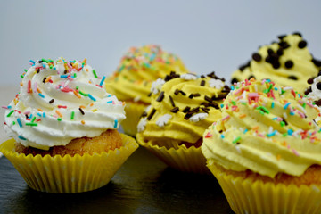 Beautiful Yellow and White Cupcakes on a Slate Plate