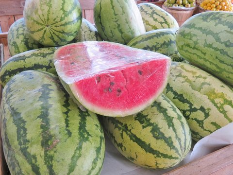 Watermelons with one sliced showing it's ripeness
