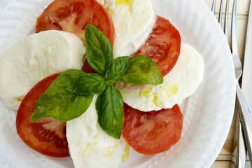 Italian Caprese Salad With Tomatoes, Mozzarella Cheese, Fresh Basils Leaves and Olive Oil