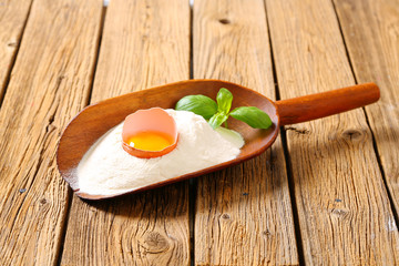 Flour and fresh egg in a scoop