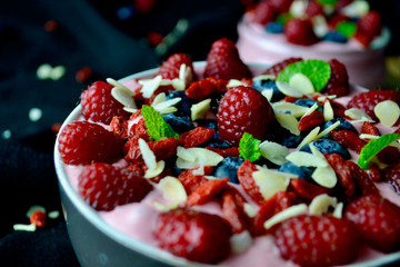 Smoothie Bowls with Raspberries, Blueberries, Goji Berries and Mint.Antioxidant Healthy Breakfast