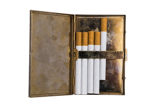 Metal vintage opened cigarette case with five cigarettes on isolated background.