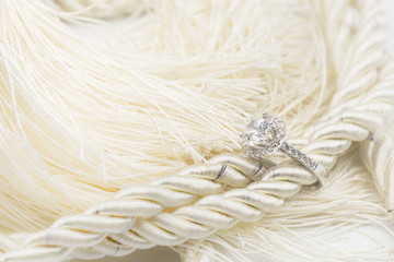 Diamond wedding rings on the white yarn. selective focus