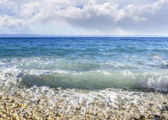 Sea beach. Sea waves crashing against the rocks on the coast.
