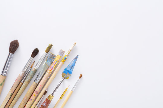 Drawing tools, set of dirty paint brushes in row