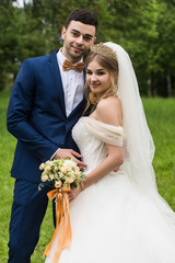 Wedding couple in the park on a walk.
