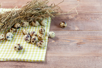 Quail eggs on the old rustic wooden table.
