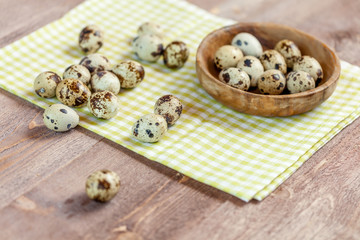 Quail eggs on the old rustic wooden table.